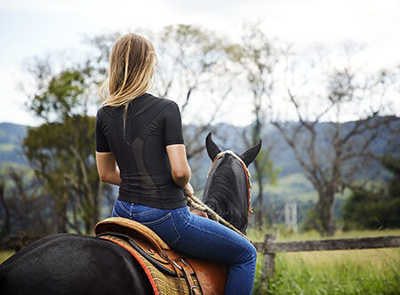 Woman on horse in an activeposture shirt