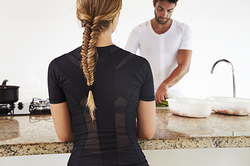 Woman and man cooking in a posture shirt